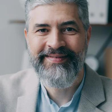 A senior interviewer listening during a remote structured interview