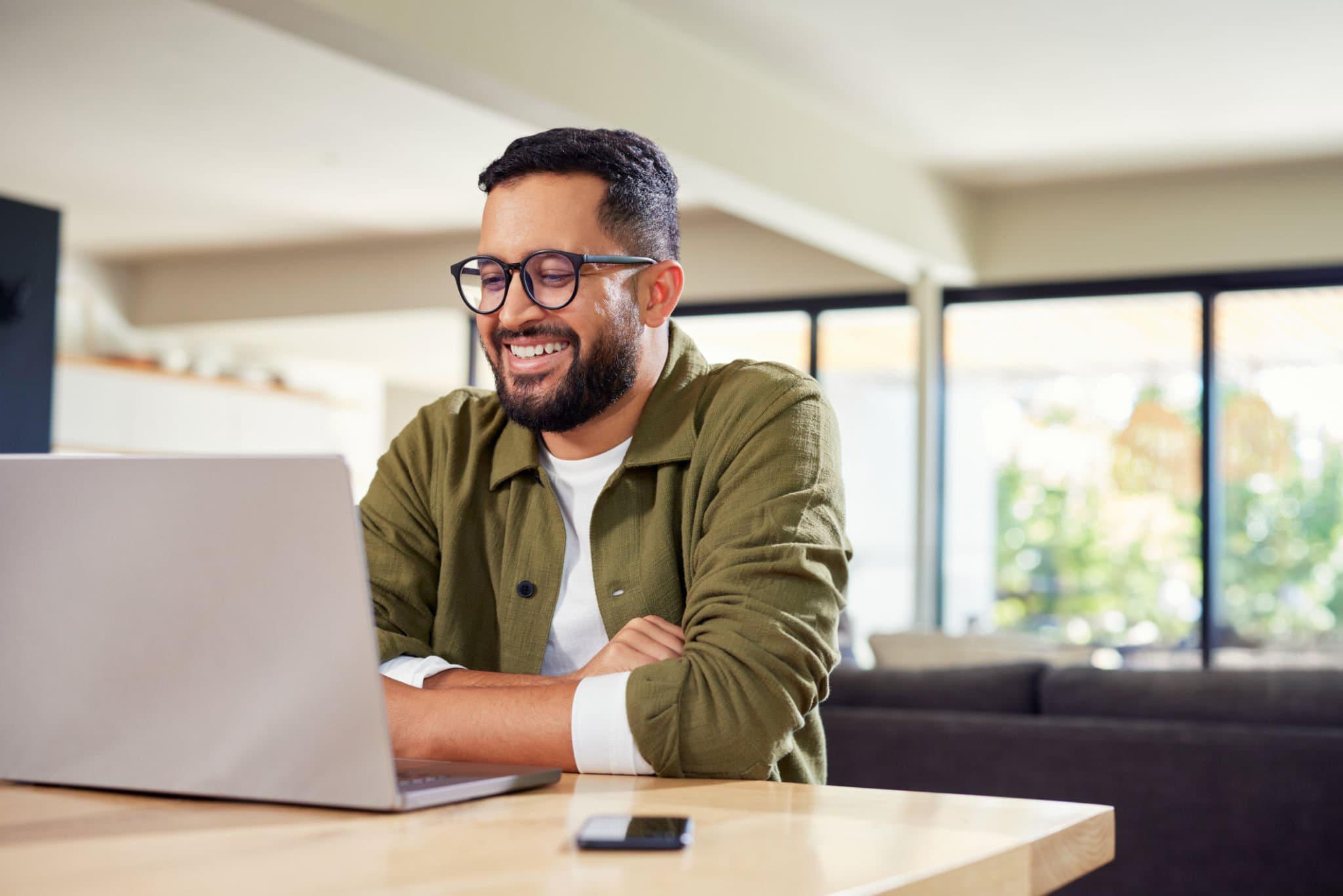 Person on video call with laptop and headphones